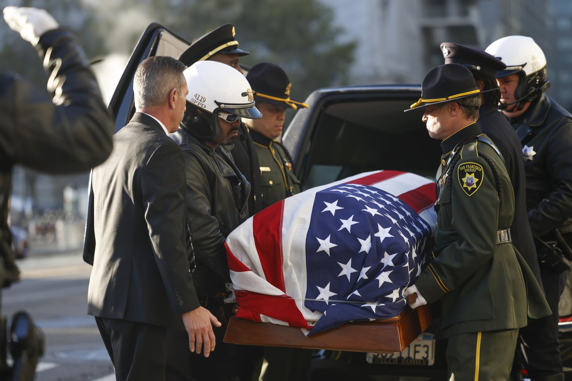 Police and sheriff's deputies carry the body of the late U.S. Sen. Dianne Feinstein into City Hall in San Francisco.