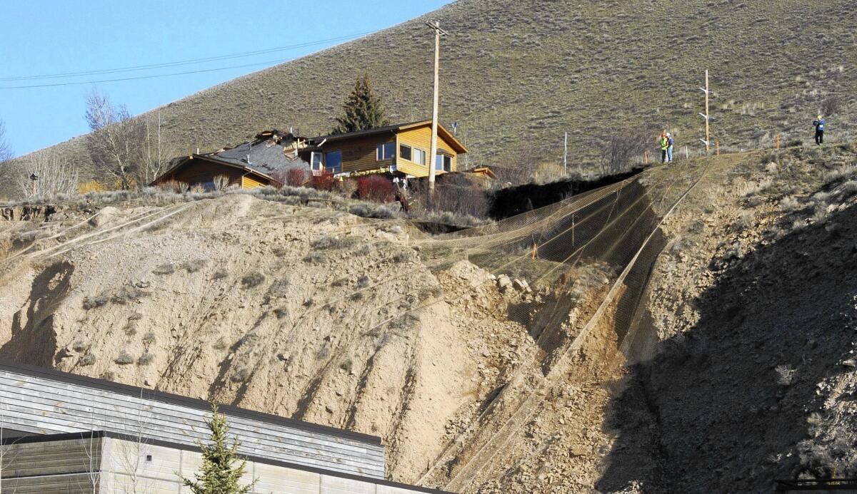 A damaged home sits atop a slow-moving landslide on East Gros Ventre Butte in Jackson, Wyo.