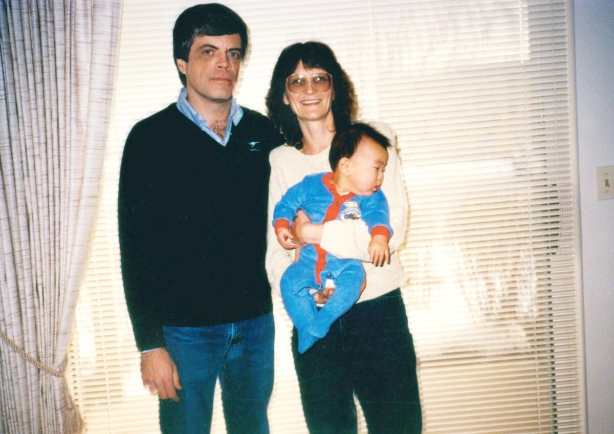 Matt Stevens is held by his parents, Jim and Jan. They were supportive of his trip back to South Korea and of him meeting his biological mother.