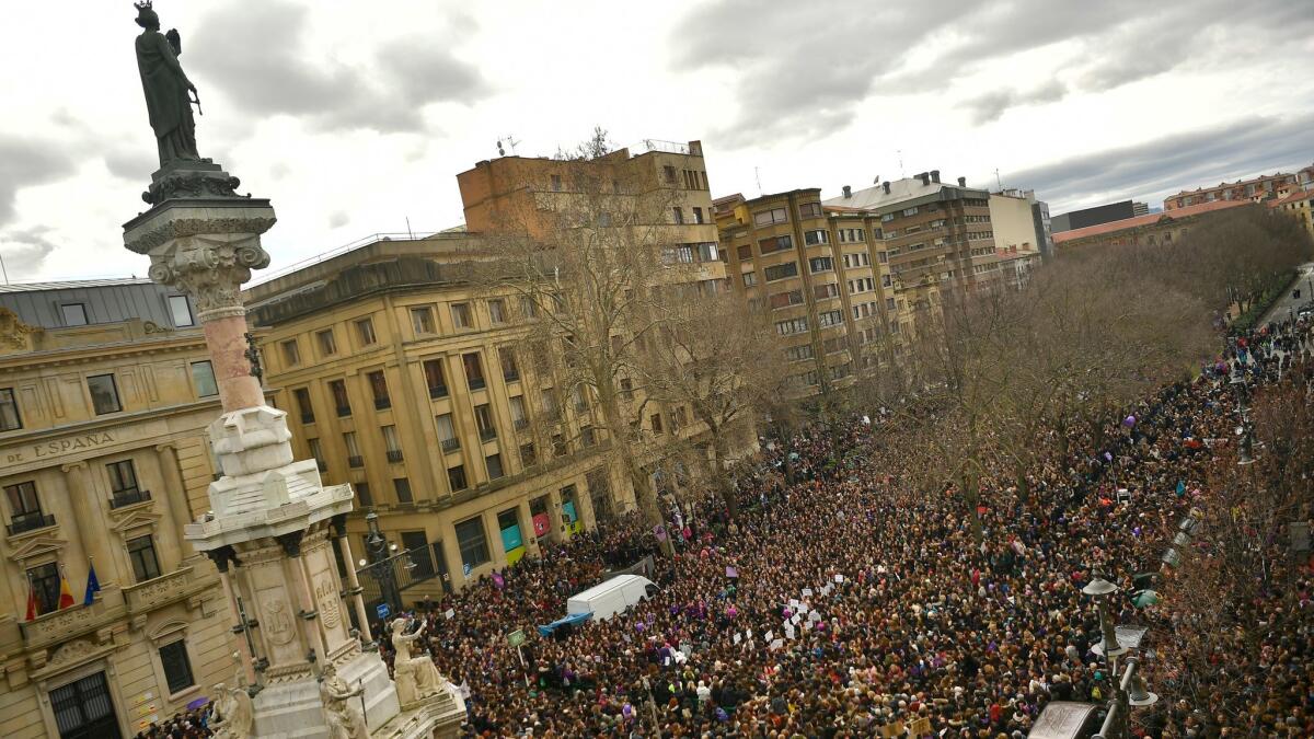 Thousands of demonstrators gather at the Paseo Sarasate Promenade in Pamplona, northern Spain, to protest violence against women and demand equal work opportunities.