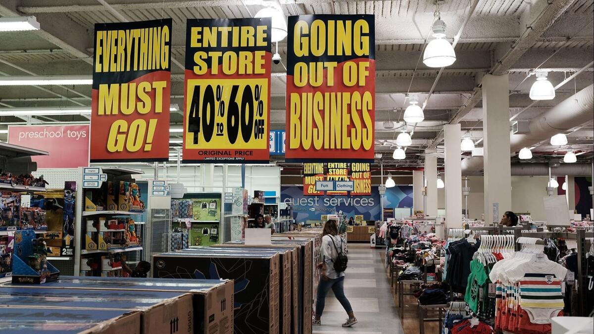 People shop on June 8 at a Toys R Us store in Brooklyn, N.Y., going through liquidation.