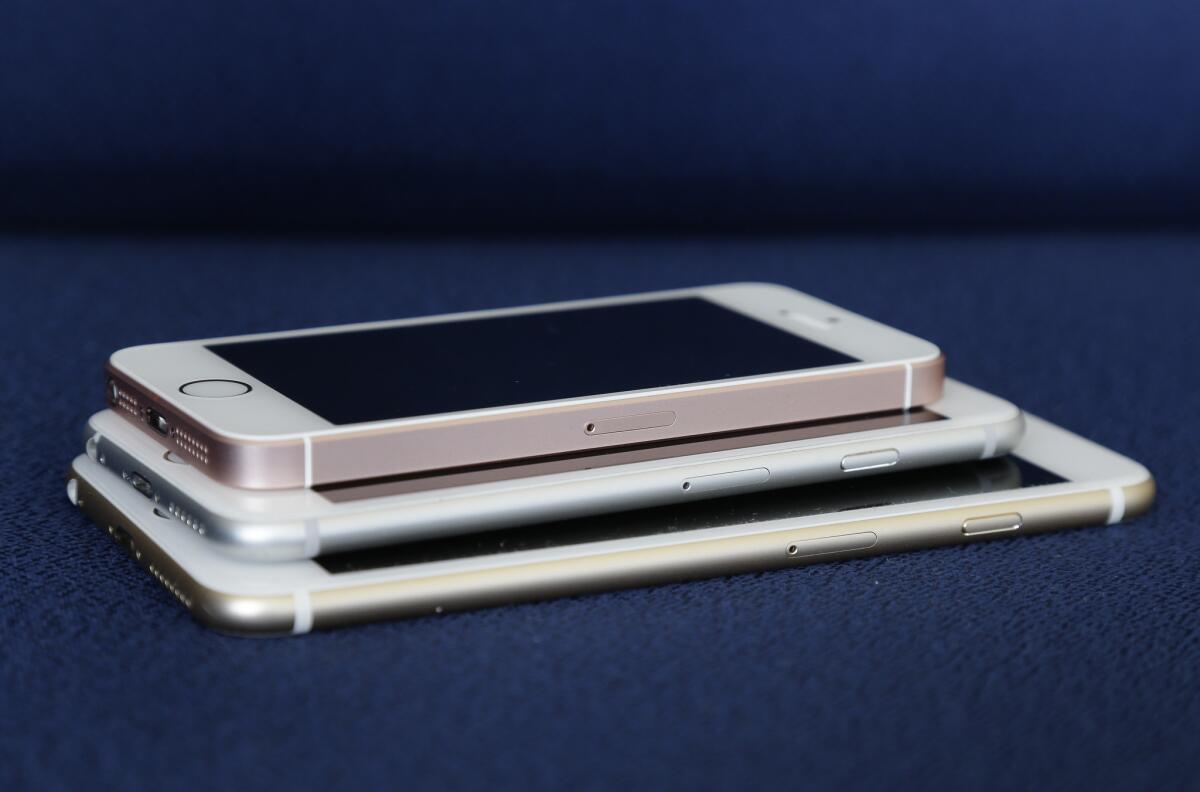 From bottom, the iPhone 6S Plus, 6S and SE lie stacked on one another in a comparison photograph, Thursday, March 24, 2016, in New York.