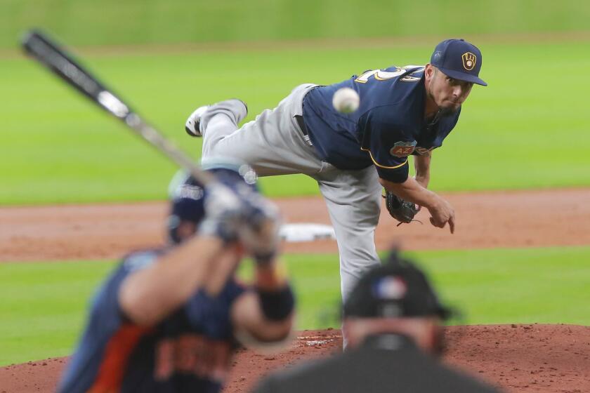 Brewers right-hander Matt Garza delivers a pitch to Astros infielder Jose Altuve during the first inning of an exhibition baseball game on April 1.