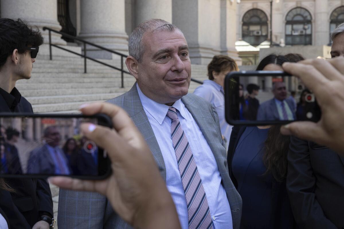 Lev Parnas, center, speaks to the media outside the federal courthouse in New York.