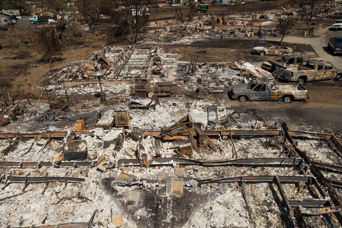 Destroyed homes and vehicles scorched by the Valley fire line Jefferson Street in Middletown, Calif, on Monday, Sept. 21, 2015.
