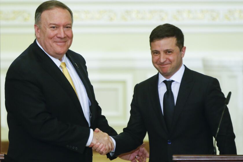 Ukrainian President Volodymyr Zelenskiy, right, and U.S. Secretary of State Mike Pompeo shake hands during a joint news conference following their talks in Kyiv, Ukraine, Friday, Jan. 31, 2020. Pompeo opened a visit to Ukraine on Friday facing a delicate balancing act as he tries to boost ties with a critical ally at the heart of the impeachment trial while not providing fodder for Democrats seeking to oust President Donald Trump. (AP Photo/Efrem Lukatsky)