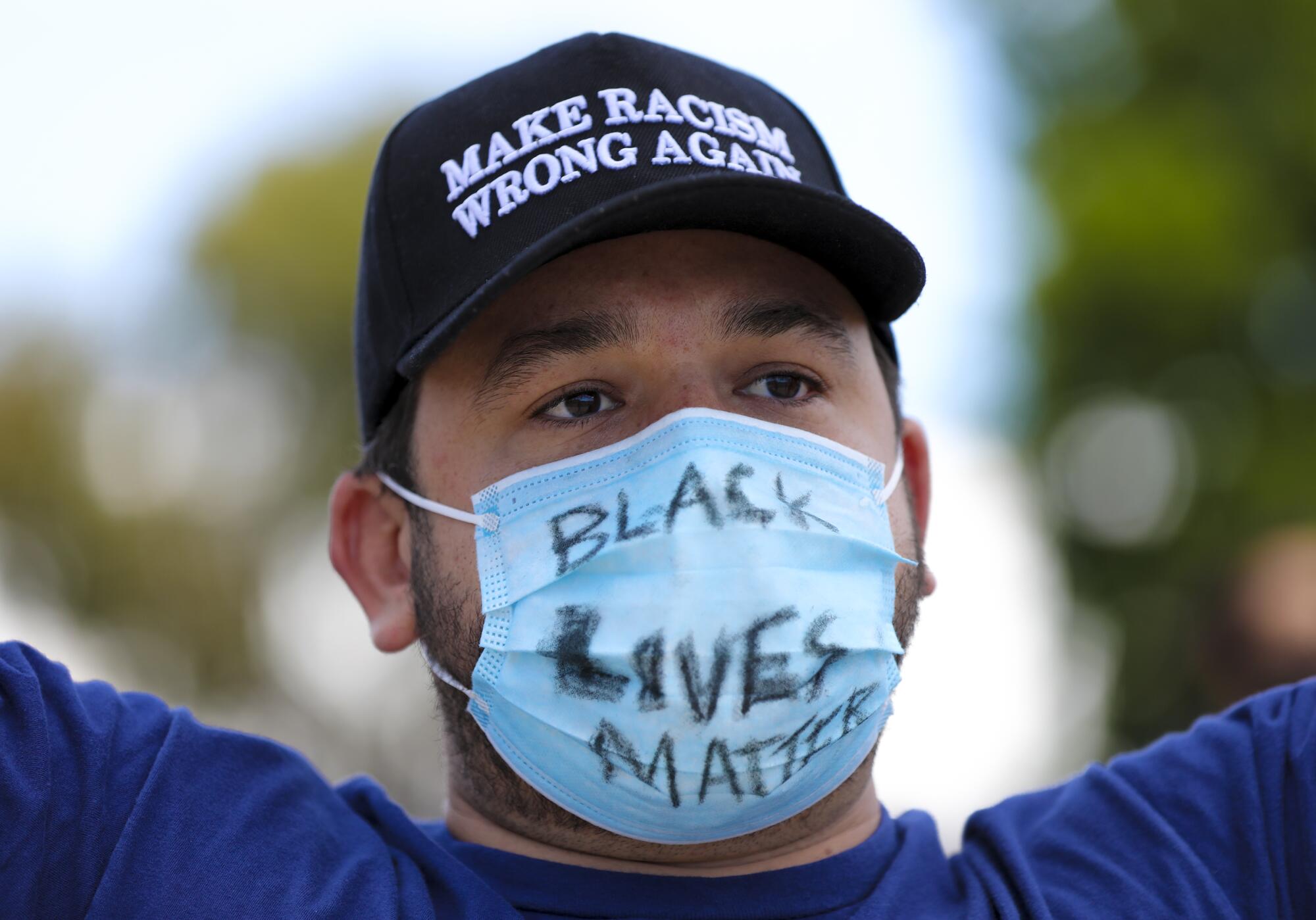 Ryan Darsey wears a facial mask with the marking "Black Lives Matters." Darsey was among the group of protestors on Saturday who began their protest in front of La Mesa Police Department.