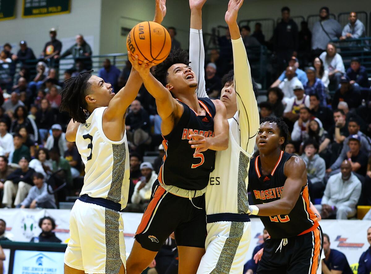 Brayden Burries of Eastvale Roosevelt goes up for a shot against St. John Bosco's Elzie Harrington (3).