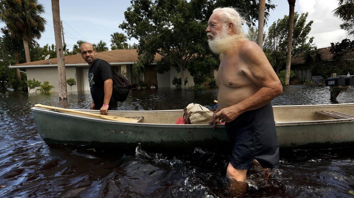 Ron Colby, 70, leaves his flooded home after staying during Hurricane Irma. He said things were OK with the wind, but at 3:30 a.m. the water started to rise.