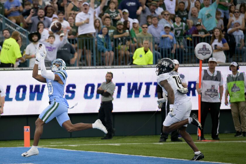 Tulane wide receiver Shae Wyatt (10) catches a touchdown pass against Central Florida cornerback Corey Thornton (14) during the first half of the American Athletic Conference championship NCAA college football game in New Orleans, Saturday, Dec. 3, 2022. (AP Photo/Matthew Hinton)