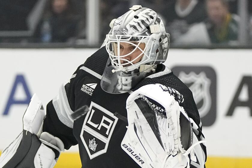 Los Angeles Kings goaltender Cam Talbot makes a glove save during the first period.