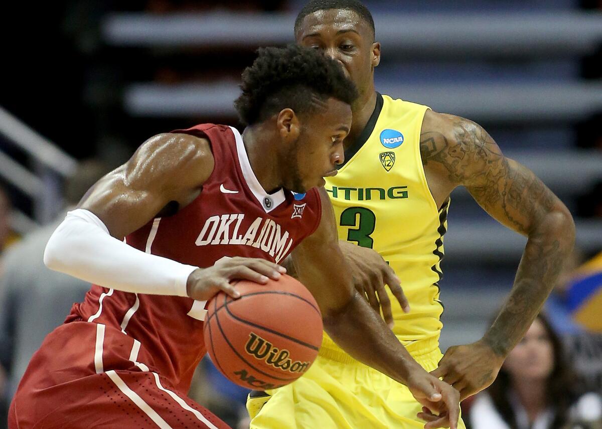 Oklahoma guard Buddy Hield drives against Oregon forward Elgin Cook in an NCAA tournament clash on March 26, 2016, at Honda Center.