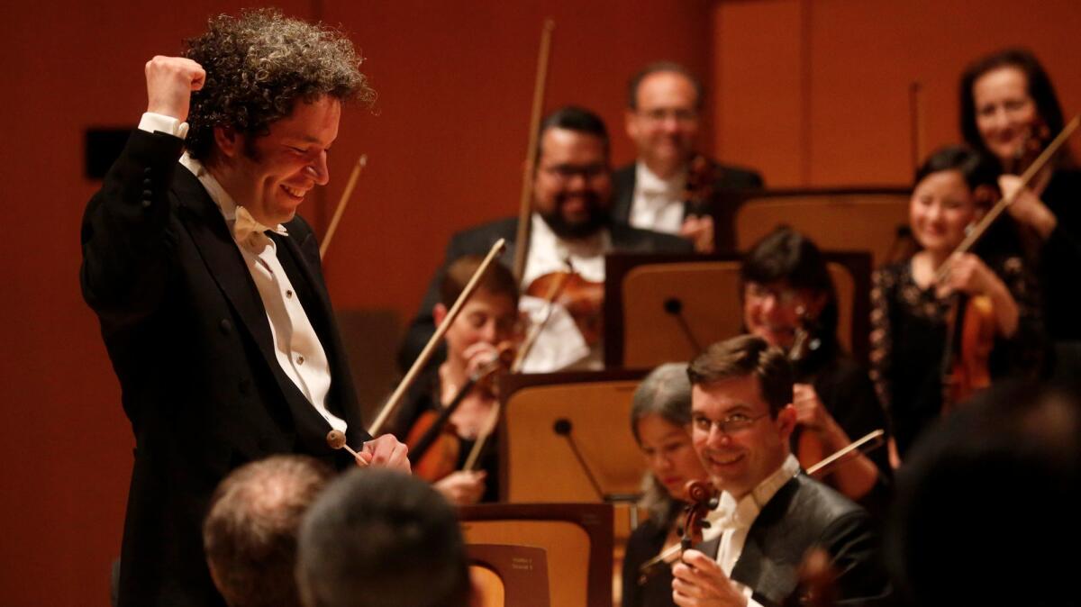 Conductor Gustavo Dudamel raises a fist acknowledging a concertgoer's hoot after the first movement of Schubert's Symphony No. 4 ("Tragic") at Walt Disney Concert Hall Thursday night.