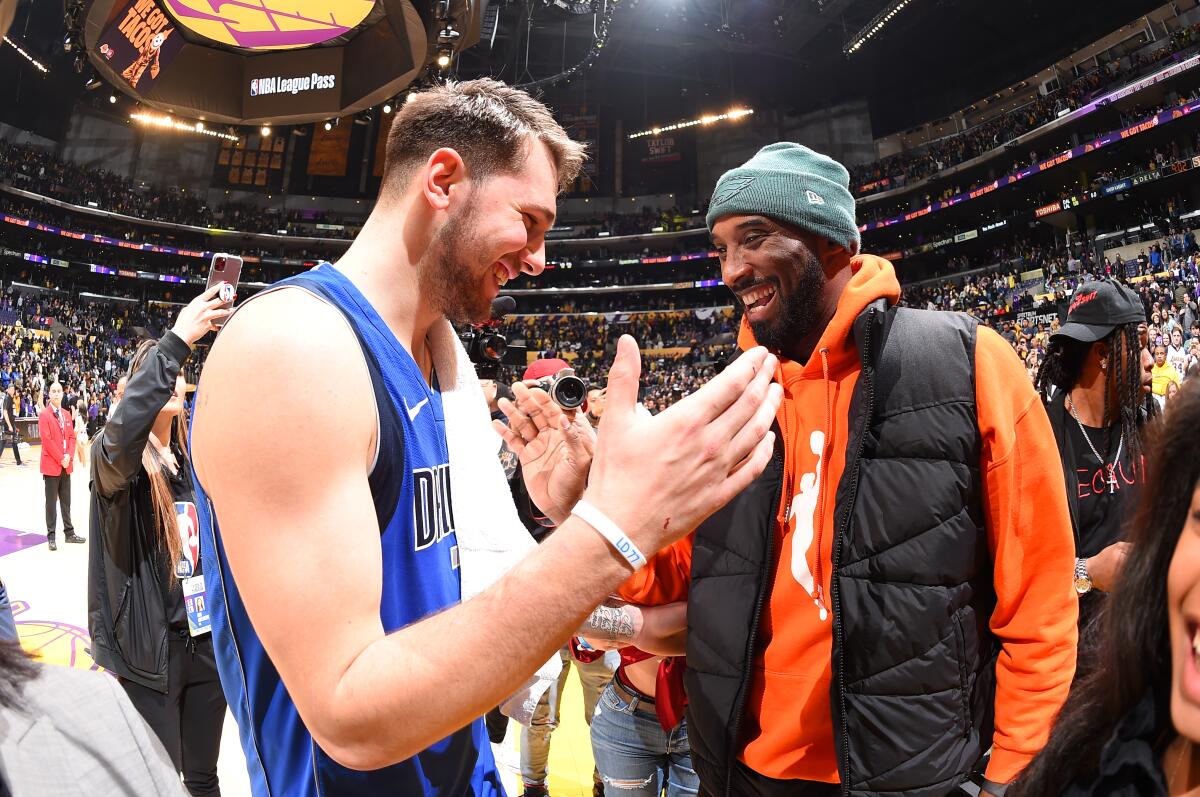 Luka Doncic and Kobe Bryant high-five after the Mavericks-Lakers game at Staples Center on Dec. 29, 2019.