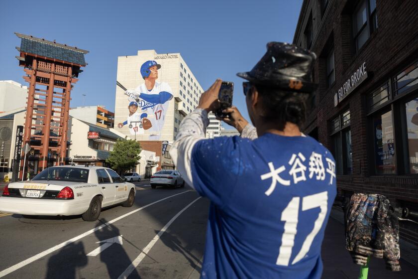 LOS ANGELES, CA- MARCH 26: Artist Robert Vargas painted a mural of newest Dodger Shohei Ohtani on the side of the Miyako Hotel in Little Tokyo. The shirt he's wearing is the sixth during this project which he plans to auction off. Vargas and others in the community hope that the mural will help boost business and tourism for small businesses in the area that were battered by the pandemic and by the rising rent and gentrification. Photographed at the Miyako Hotel in Little Tokyo in Los Angeles, CA on Tuesday, March 26, 2024. (Myung J. Chun / Los Angeles Times)