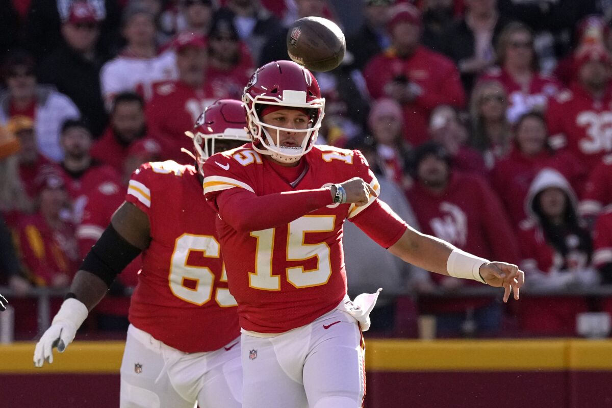 Kansas City Chiefs quarterback Patrick Mahomes (15) throws during the first half of an NFL football game against the Las Vegas Raiders Sunday, Dec. 12, 2021, in Kansas City, Mo. (AP Photo/Charlie Riedel)
