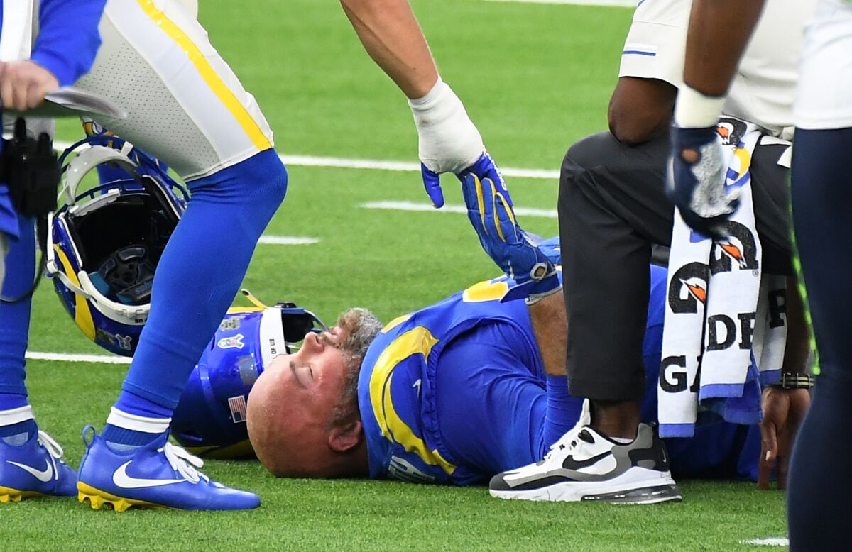Trainers attend to Rams offensive lineman Andrew Whitworth, who hurt his knee in a game against Seattle on Sunday.  
