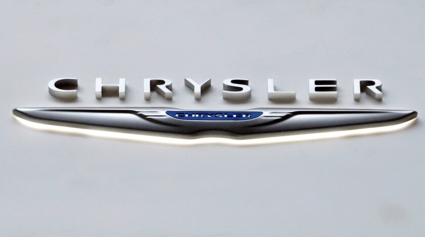 FILE - The Chrysler logo at the 2019 Pittsburgh International Auto Show is displayed on Feb. 14, 2019. Chrysler says, Wednesday, Jan. 5, 2022, it plans for its vehicle lineup to go all electric by 2028. It's the latest brand to announce a major shift away from gas-powered cars amid pressure to act on climate change. (AP Photo/Gene J. Puskar, file)