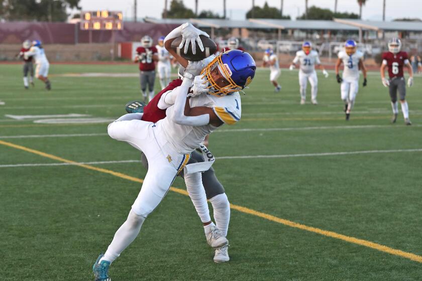 Fountain Valley reciver makes an over the shoulder catch in the endzone.