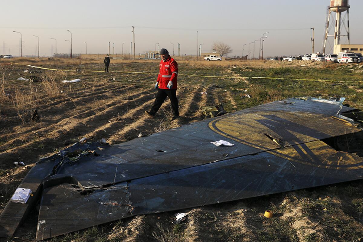 A rescue worker at the scene of plane crash near Tehran on Wednesday.