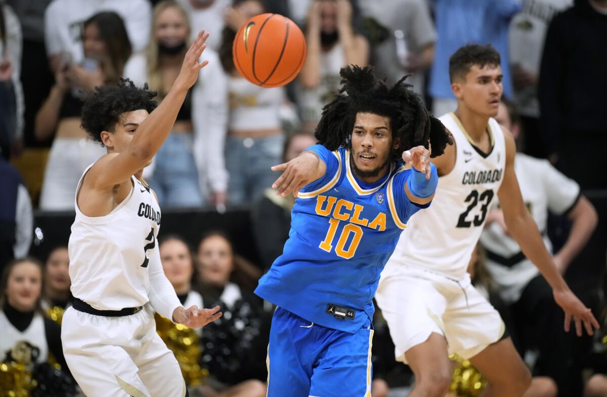 UCLA guard Tyger Campbell passes the ball as Colorado guard KJ Simpson, left, defends during the second half.