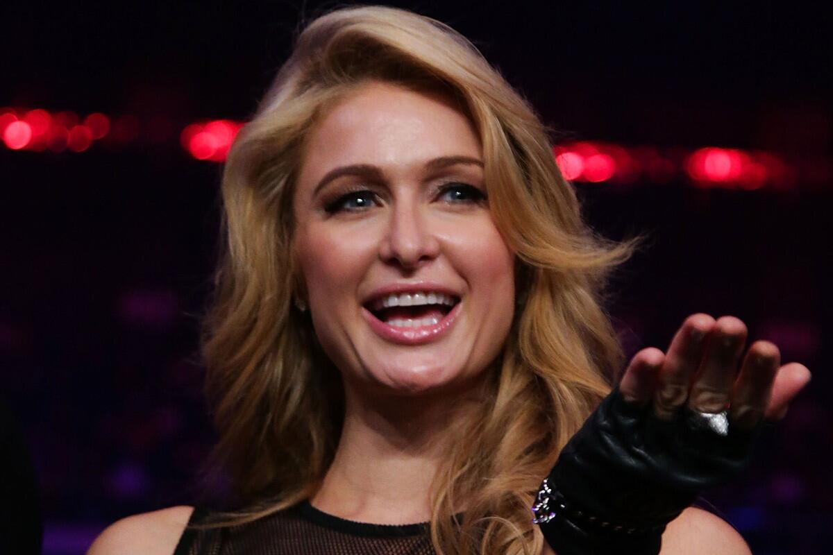 Paris Hilton, shown at the Manny Pacquiao-Brandon Rios fight in Macao in November, was not pleased about a hoax tweet circulated as coming from her after the Thursday death of Nelson Mandela.