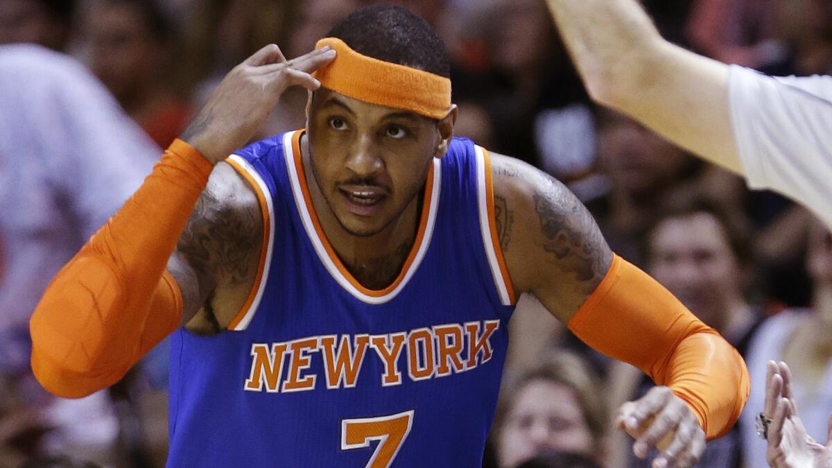 New York Knicks forward Carmelo Anthony reacts after making a three-pointer against the Miami Heat on Feb. 9. Anthony reportedly will undergo season-ending knee surgery.