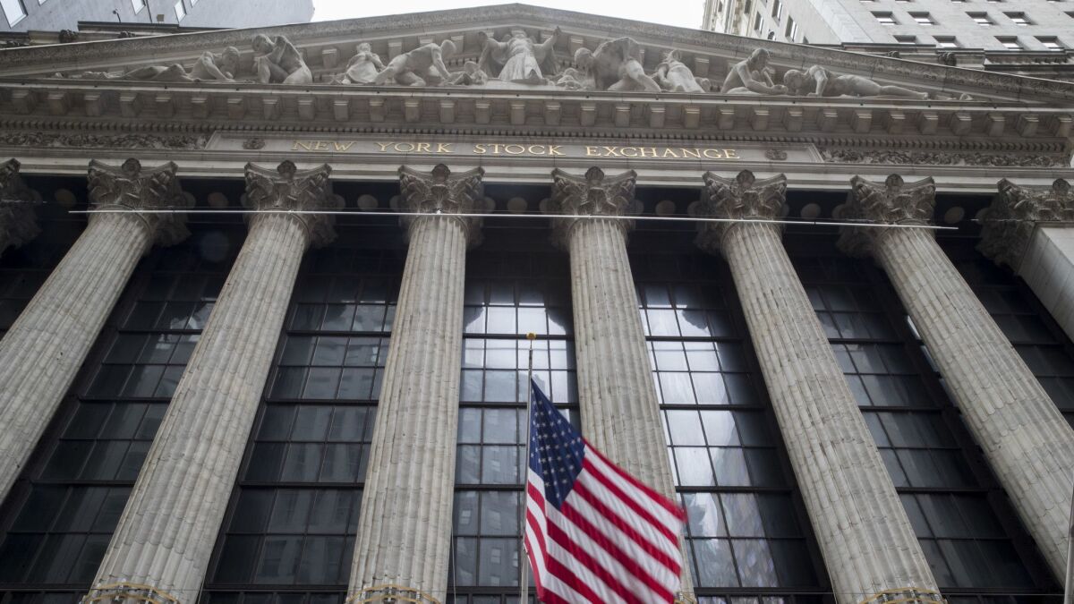 A U.S. flag flies outside New York Stock Exchange.