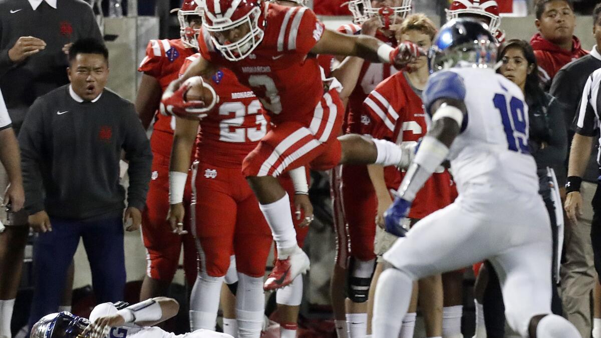 Mater Dei running back Shakobe Harper, hurdling an IMG Academy defender earlier this season, has 1,150 yards rushing and 17 touchdowns this season.