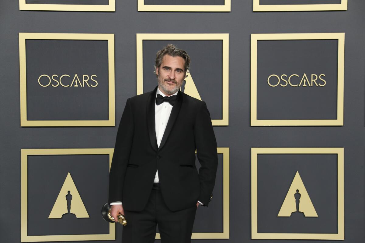 Joaquin Phoenix holds his Oscar at the 92nd Academy Awards
