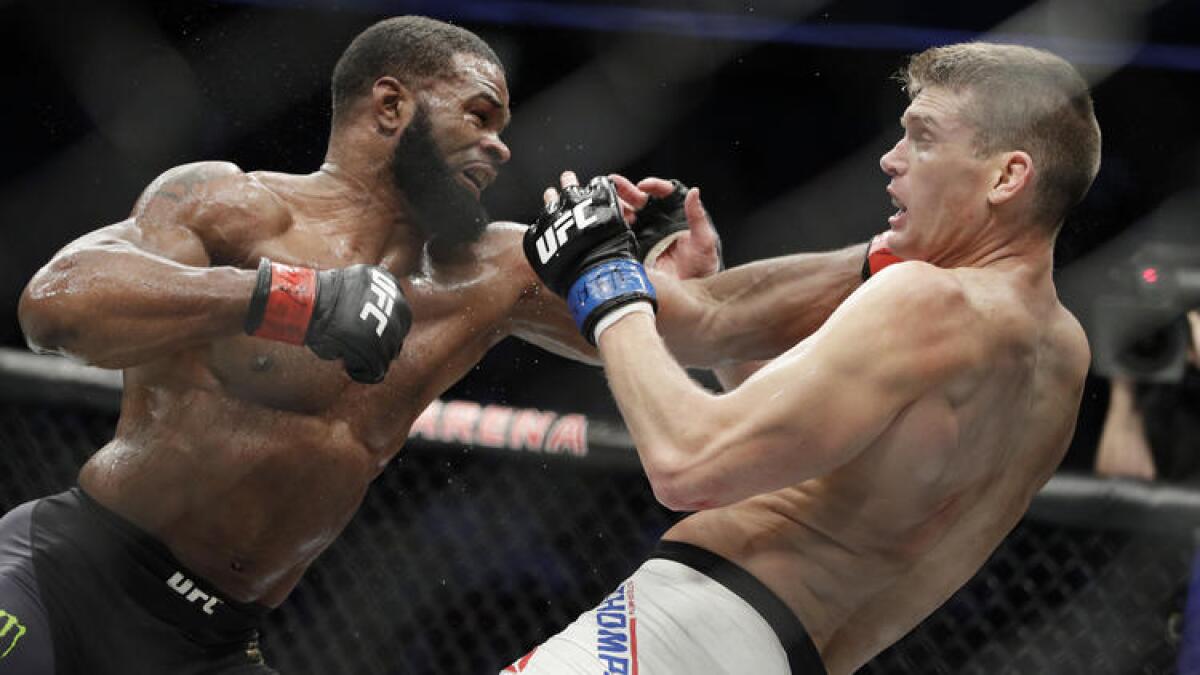 Tyron Woodley sends Stephen Thompson reeling during their welterweight championship fight. To see more images from UFC 209, click on the photo above.