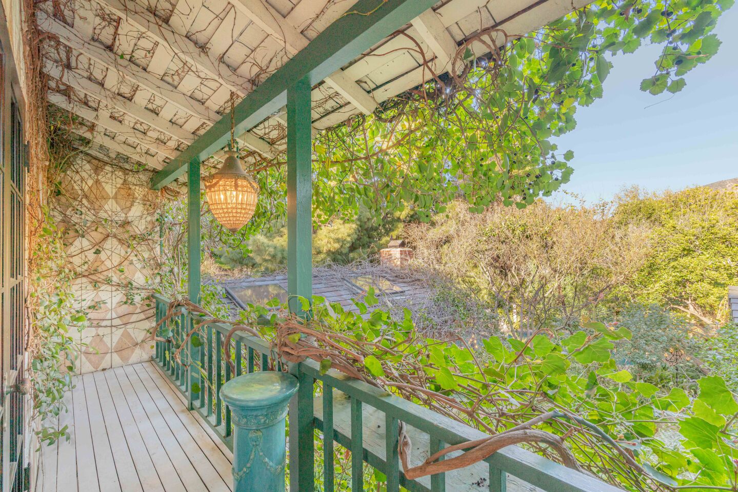 A balcony off the master suite overlooks the lush property.