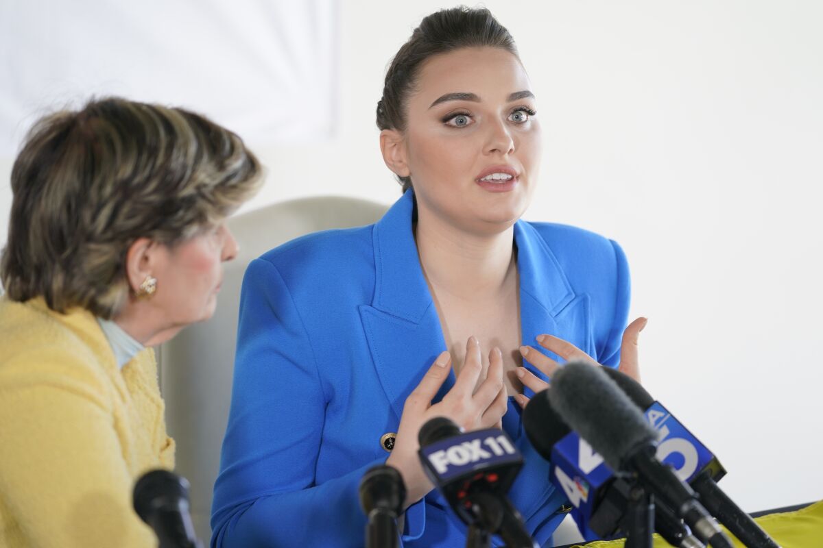 Veronica Didusenko, Miss Ukraine 2018, describes how she was forced to flee from Ukraine with her 7-year-old son, during a news conference at the office of her attorney, Gloria Allred, in Los Angeles, Tuesday, March 8, 2022. Didusenko and her son fled the country on Feb. 24, 2022, when Russia began to bomb Kyiv, their home city. (AP Photo/Damian Dovarganes)