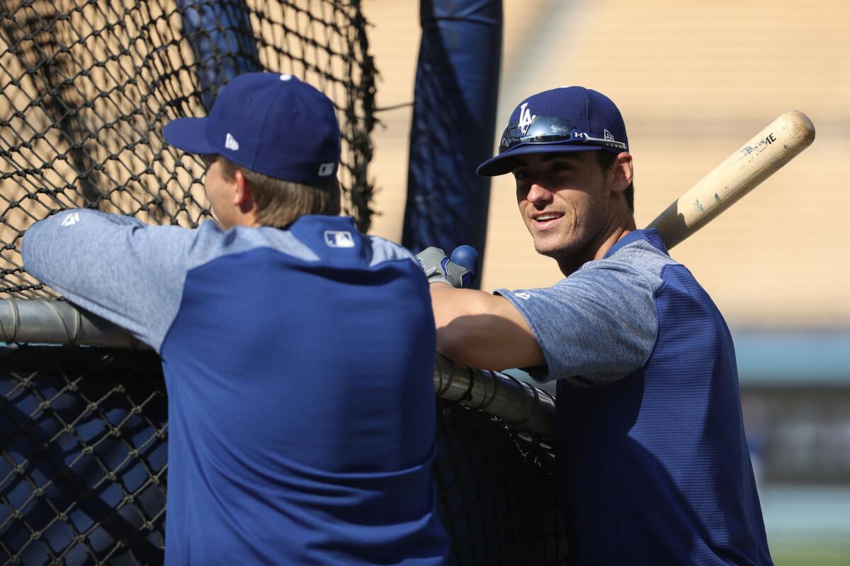 Cody Bellinger chats with a teammate before a batting practice at Dodger Stadium.