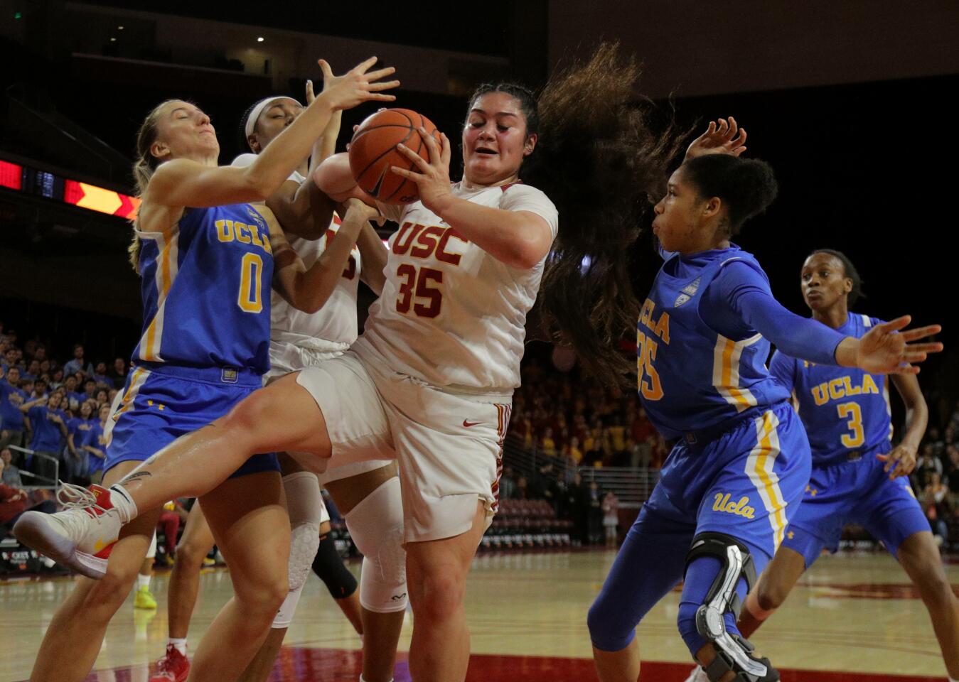 USC forward Alissa Pili (35) boxes out UCLA guards Chantel Horvat (0) and Camryn Brown (35) to grabs a defensive rebound during the first half of a game Jan. 17 at Galen Center.