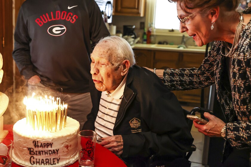 Former Georgia All-American Charley Trippi celebrates his 100th birthday at his home in Athens, Ga., on Tuesday, Dec. 14, 2021. Trippi played for Georgia in the 1940s, his college career interrupted by a stint in the military during World War II. (Tony Walsh/UGA Athletic Association via AP)