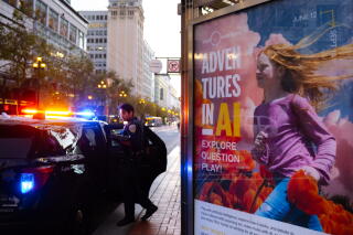 A police officer shuts the door to his vehicle