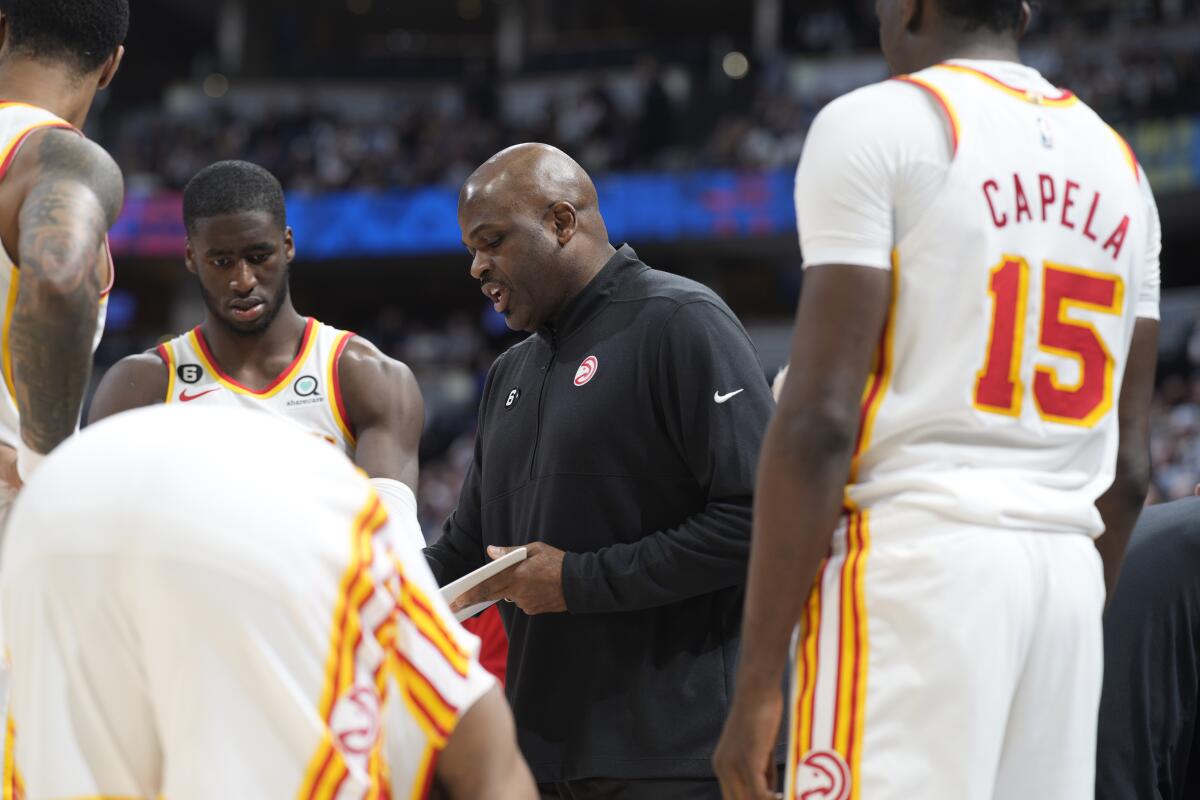Atlanta Hawks coach Nate McMillan draws up a play during a game on Feb. 4, 2023, in Denver.