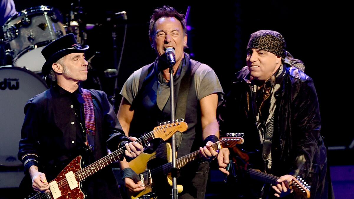 Nils Lofgren, left, Bruce Springsteen and Steven Van Zandt at the L.A. Sports Arena on March 15. (Kevin Winter / Getty Images)