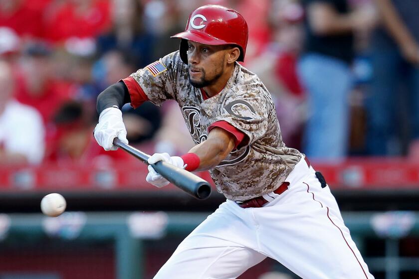 Reds center fielder Billy Hamilton lays down a bunt against the Cardinals during a game Sept. 2.