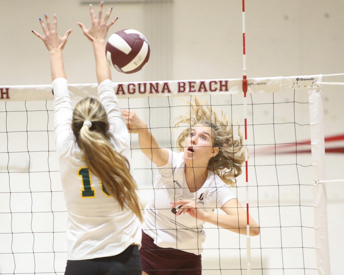 Laguna Beach's Sophia Reavis, right, hits a shot past Manhattan Beach Mira Costa's Amanda Burns in the first round of the CIF Southern Section Division 1 playoffs at home Thursday.
