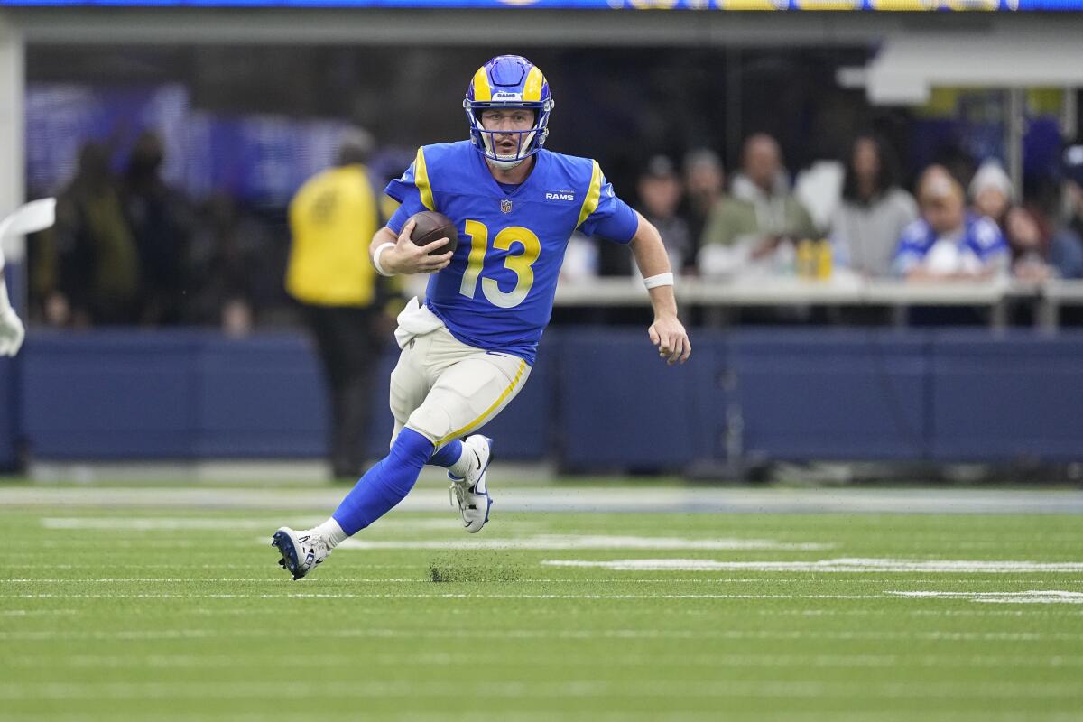 Rams quarterback John Wolford runs with the ball during the first half against the Seahawks.