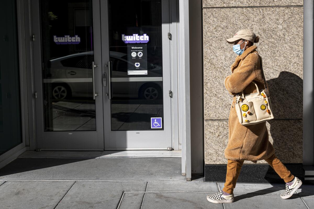 A pedestrian walks past Twitch headquarters in San Francisco.