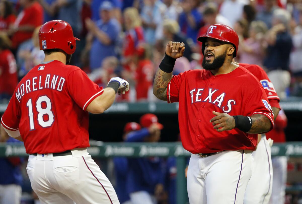 Mitch Moreland (18) and Prince Fielder, right, celebrate after Moreland's three-run home run off of Angels starter Matt Shoemaker during the third inning of a game on April 30.