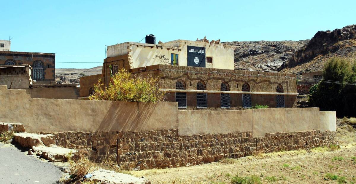 A painting of the black flag brandished by the militant group Al Qaeda in the Arabian Peninsula marks the wall of Adnan Qadhi's house in the Yemeni village of Beit al Ahmar. Qadhi was killed by a U.S. drone strike in November.