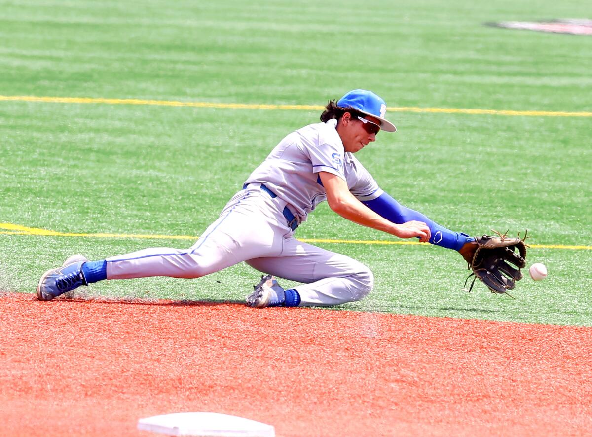 Jared Saldana of Santa Margarita makes diving catch in 2-1 victory over Corona on Tuesday in the Boras Classic.