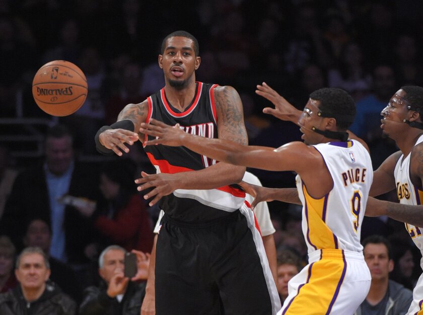 Portland Trail Blazers forward LaMarcus Aldridge, left, passes the ball past Lakers guard Ronnie Price, center, and forward Ed Davis back in January.