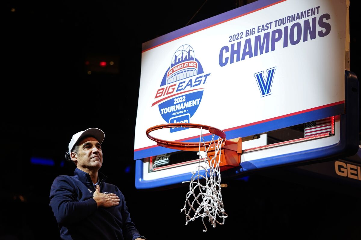 Villanova head coach Jay Wright gestures to supporters while cutting down the net after the final of the Big East conference tournament against Creighton, Saturday, March 12, 2022, in New York. (AP Photo/Frank Franklin II)