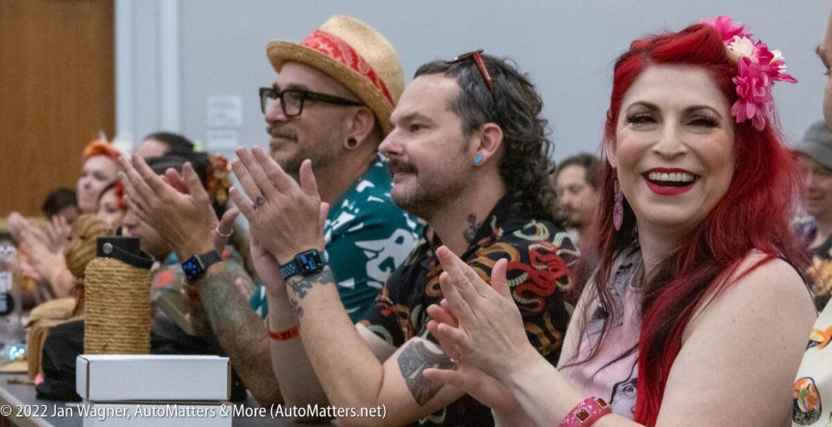 Attendees applauding at the event.