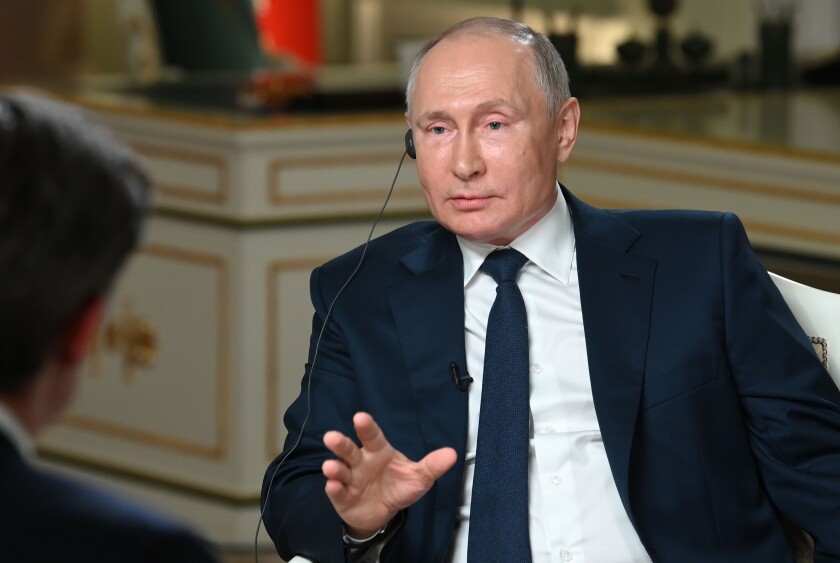 Russian President Vladimir Putin speaks to NBC News journalist Keir Simmons, back to a camera, in an interview aired on Monday, June 14, 2021, two days before the Russian leader is to meet U.S. President Joe Biden in Geneva. Putin has sharply dismissed allegations that his country is carrying out cyberattacks against the United States as baseless. (Maxim Blinov, Sputnik, Kremlin Pool Photo via AP)